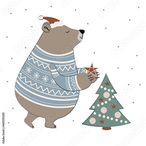 Cute cartoon bear in a sweater and winter hat decorate a Christmas tree