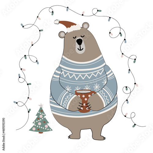 Cute cartoon bear in a sweater and winter hat holds a mug