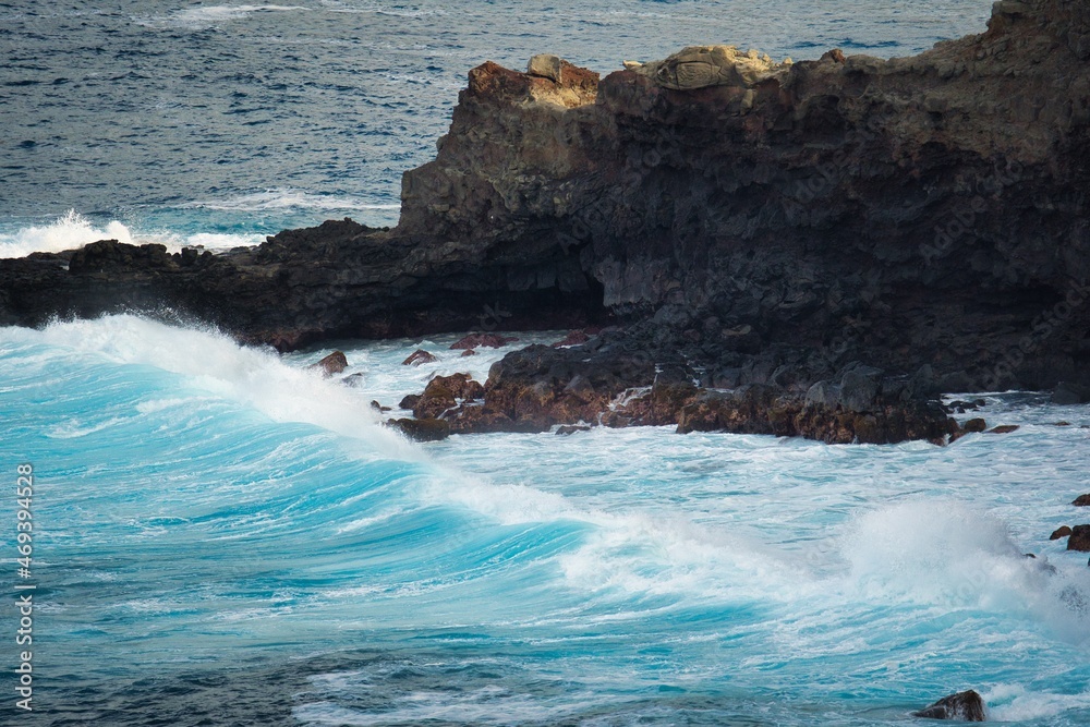 Waves crash into cliffs on the north shore of Maui, Hawaii. 