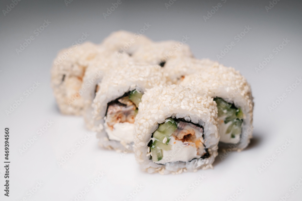 Sushi set with salmon, tuna and cream cheese close-up. Traditional Japanese cuisine side view. Sushi set with salmon, tuna and cream cheese close-up. Traditional Japanese cuisine side view.
