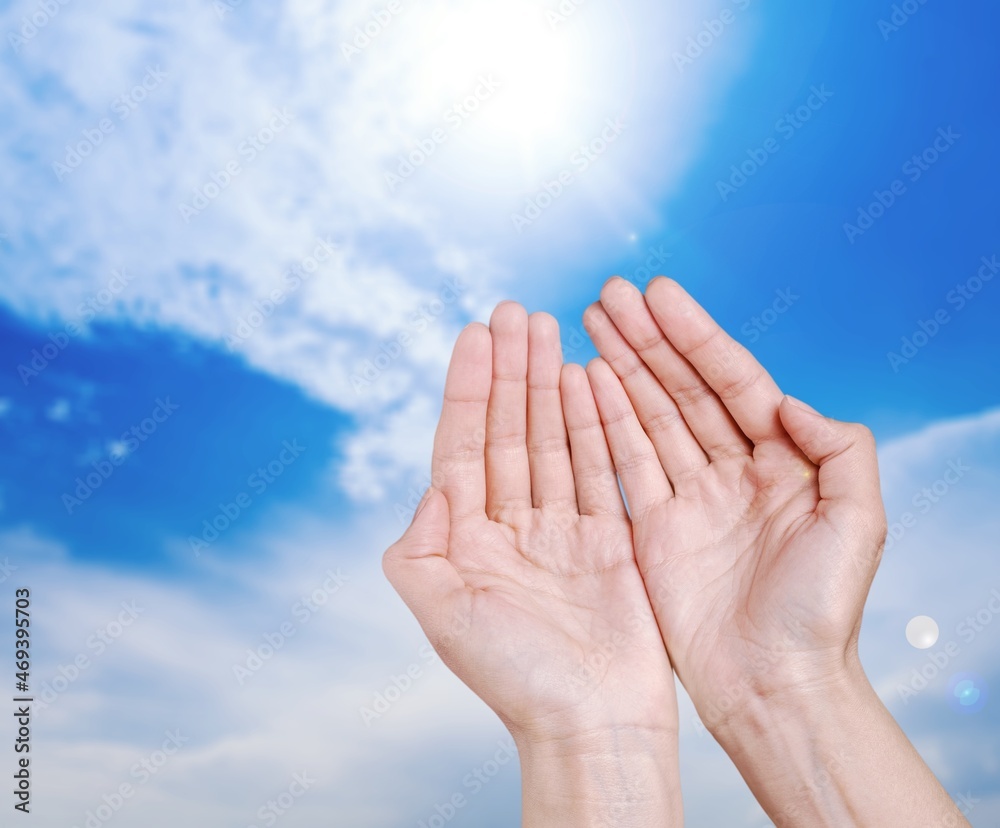Hands of human praying on sky background with sunlight, Spirituality with believe and religion Hands of human praying on sky background with sunlight, Spirituality with believe and religion