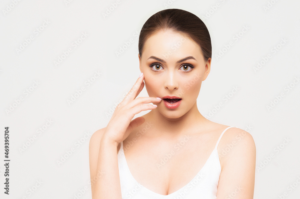 Pretty woman with clear skin. SPA concept. Natural beauty. Surprised expression Pretty woman with clear skin. SPA concept. Natural beauty. Surprised expression