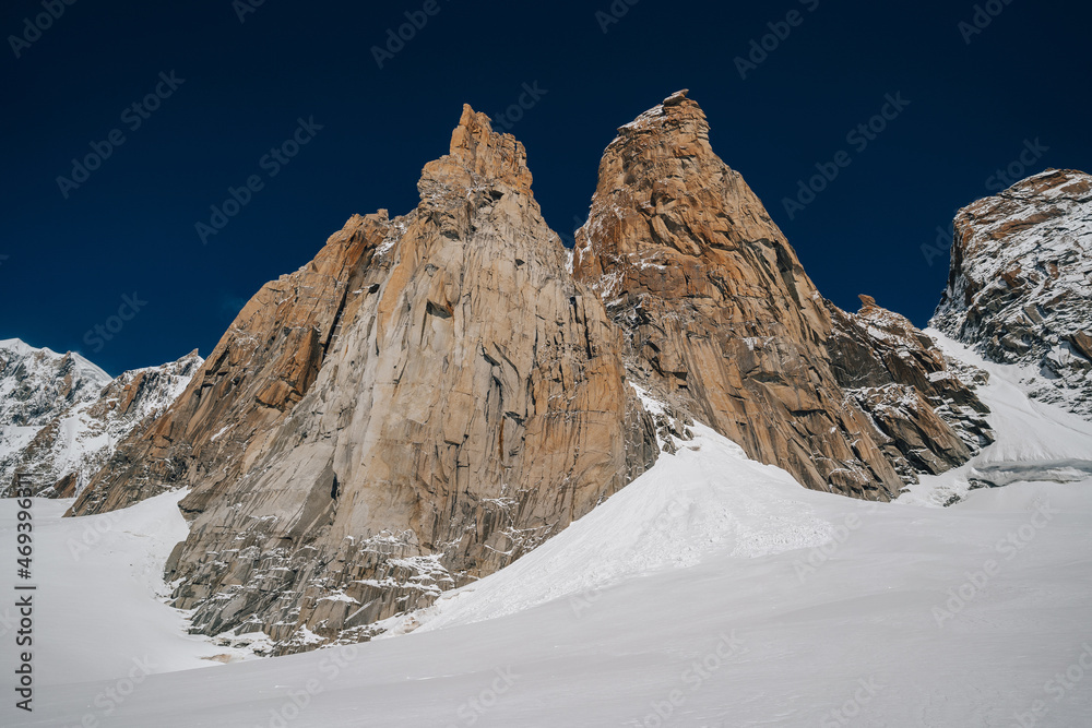 Alpine mountain landscape of Mont Blanc Masiff, Chamonix, France. Alpine peaks, Aiguille du Midi and other famous alpine mountains. Alpinism, climbing, glaciers and snow.