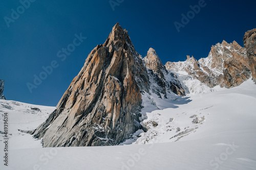 Alpine mountain landscape of Mont Blanc Masiff, Chamonix, France. Alpine peaks, Aiguille du Midi and other famous alpine mountains. Alpinism, climbing, glaciers and snow.