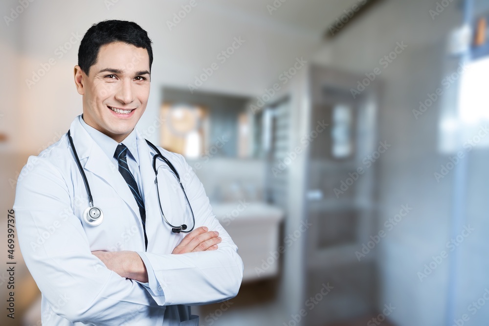 Smiling doctor wearing medical coat looking at camera. Smiling doctor wearing medical coat looking at camera.