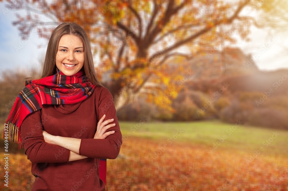 Beautiful young woman relaxing at park during autumn season with foliage in the background. Beautiful young woman relaxing at park during autumn season with foliage in the background.