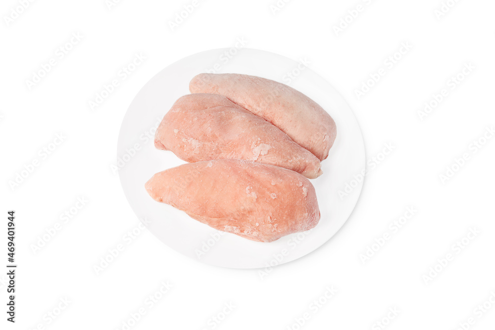 Three pieces of raw frozen fillet on a white plate on a white plate copy space.Frozen chicken fillet.
