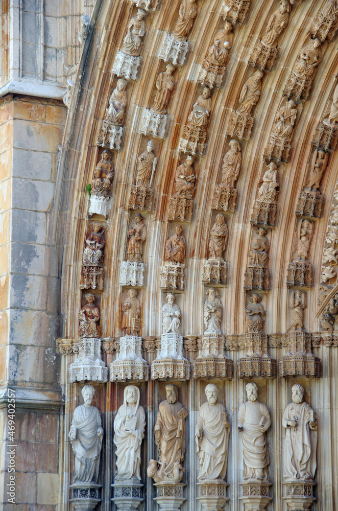 A detailed view of stone figures on the arched entrance at medieval Batalha monastery A detailed view of stone figures on the arched entrance at medieval Batalha monastery