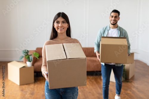 Happy man and woman holding cardboard boxes, relocation concept