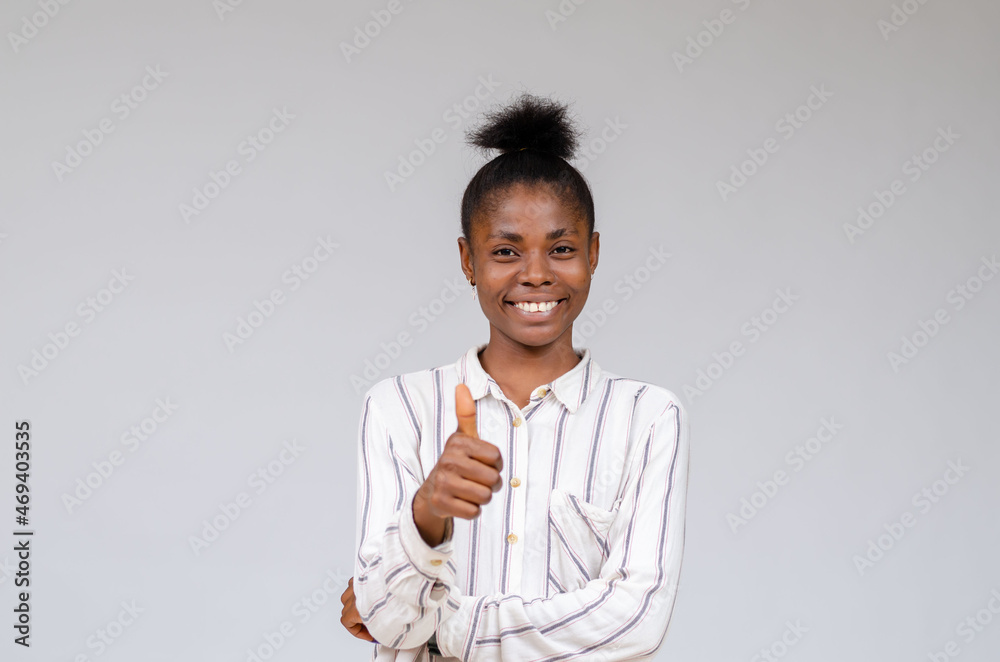 close up of beautiful african lady isolated over white background smiling as she did thumbs up close up of beautiful african lady isolated over white background smiling as she did thumbs up