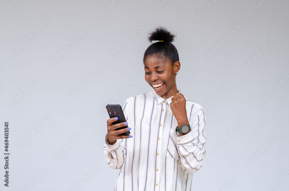 young lady feeling excited about what she saw on her phone young lady feeling excited about what she saw on her phone