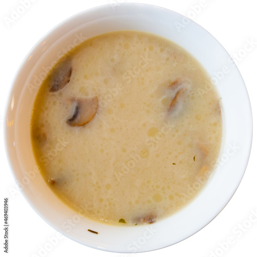 Portion of fresh mushroom soup served in soup bowl. Isolated over white background