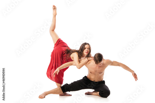 Couple of ballet dancers posing isolated over white background