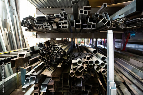 Metal profile of the pipe lies on the shelves in the workshop. High quality photo