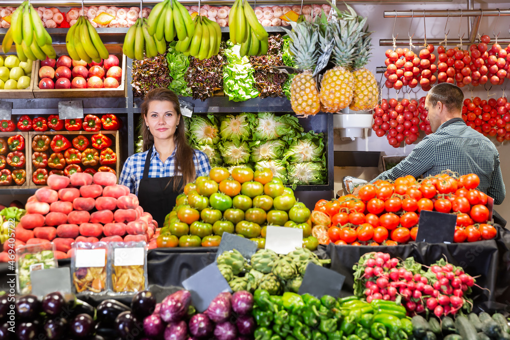 Portrait of male and female shop assistants working in a fruit and vegetable shop