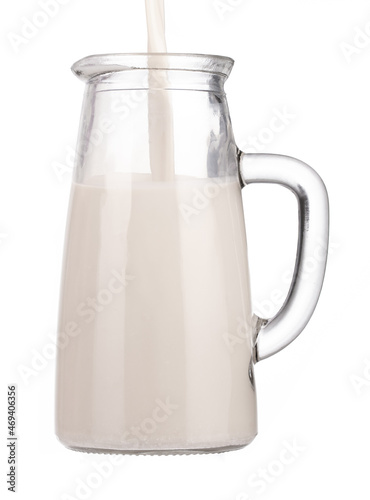 Milk Pouring Into Jug ​isolated on a white background.