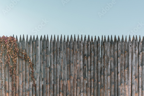 Palisade of vertical logs, a fence of wooden bars installed against enemies for mediaeval fortress. Control. Stop. Area