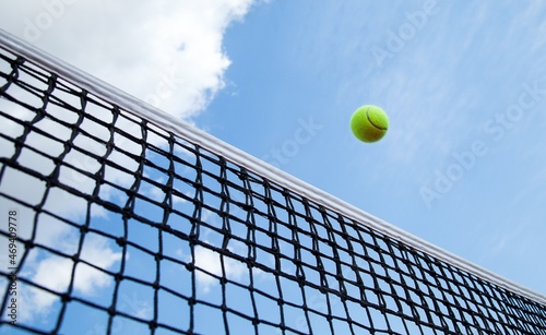 Tennis ball flying over net © BillionPhotos.com