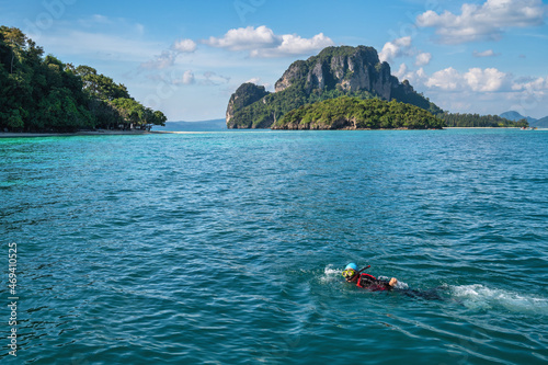 Tropical islands view with snorkeling driving tourist at ocean blue sea water and white sand beach, Krabi Thailand nature landscape
