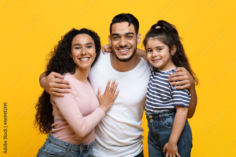 Happy Loving Family. Portrait Of Beautiful Young Arab Parents And Little Daughter Happy Loving Family. Portrait Of Beautiful Young Arab Parents And Little Daughter