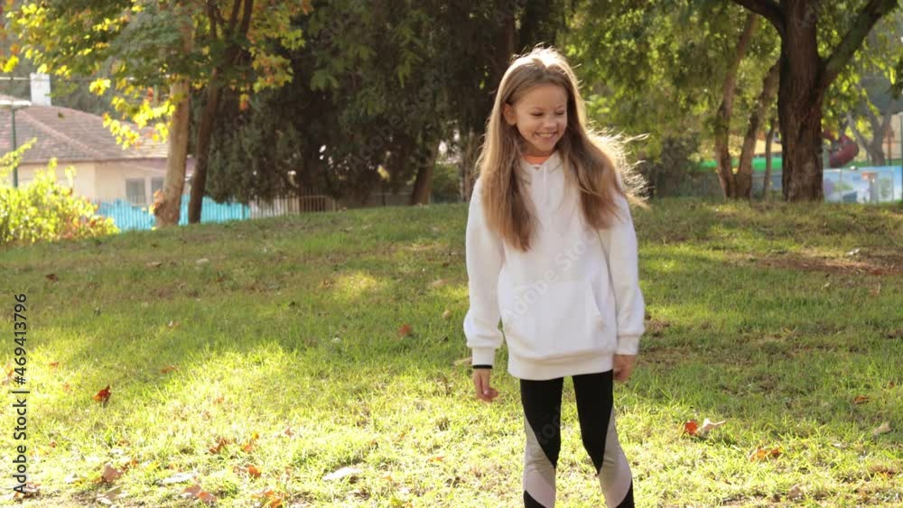 Cute girl collecting autumn leaves in park Cute girl collecting autumn leaves in park