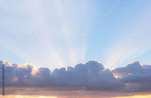 Panorama of the sky with clouds and lit by the light of the sunset.