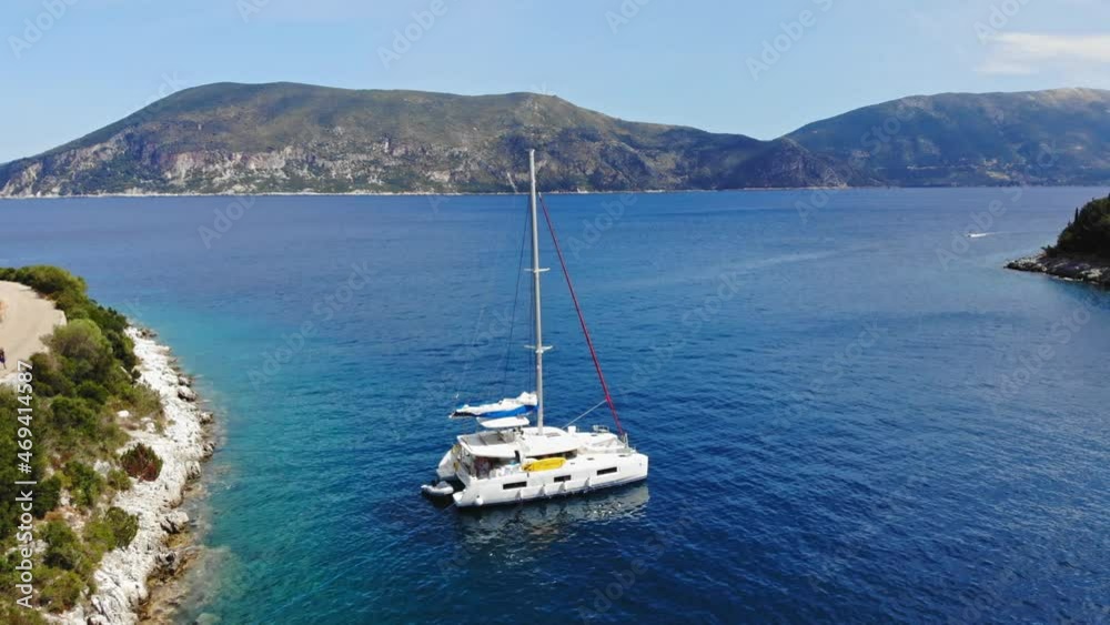 Boats Floating On Calm Blue Sea In Foki Beach, Kefalonia, Greece. aerial pullback Boats Floating On Calm Blue Sea In Foki Beach, Kefalonia, Greece. aerial pullback