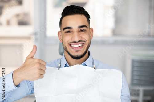 Dental Services. Happy Arab Guy Sitting In Dentist Chair, Showing Thumb Up
