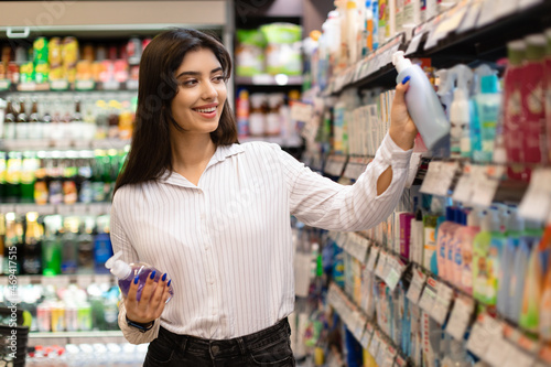 Arabic Woman Choosing Household Cleaning Products Doing Shopping In Supermarket