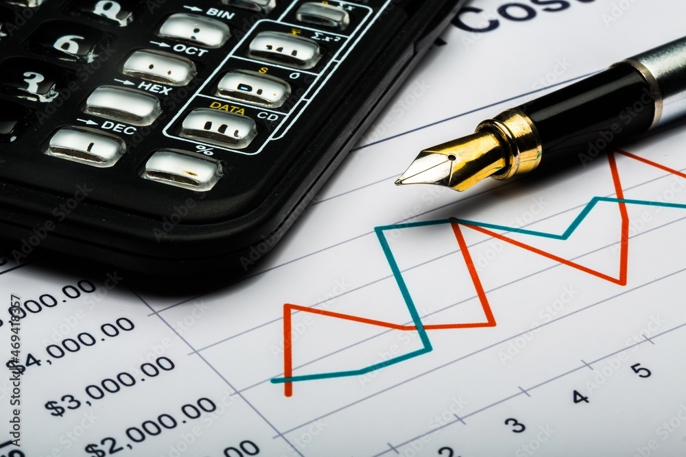 Calculator and Pen on Business Graphs Calculator and Pen on Business Graphs