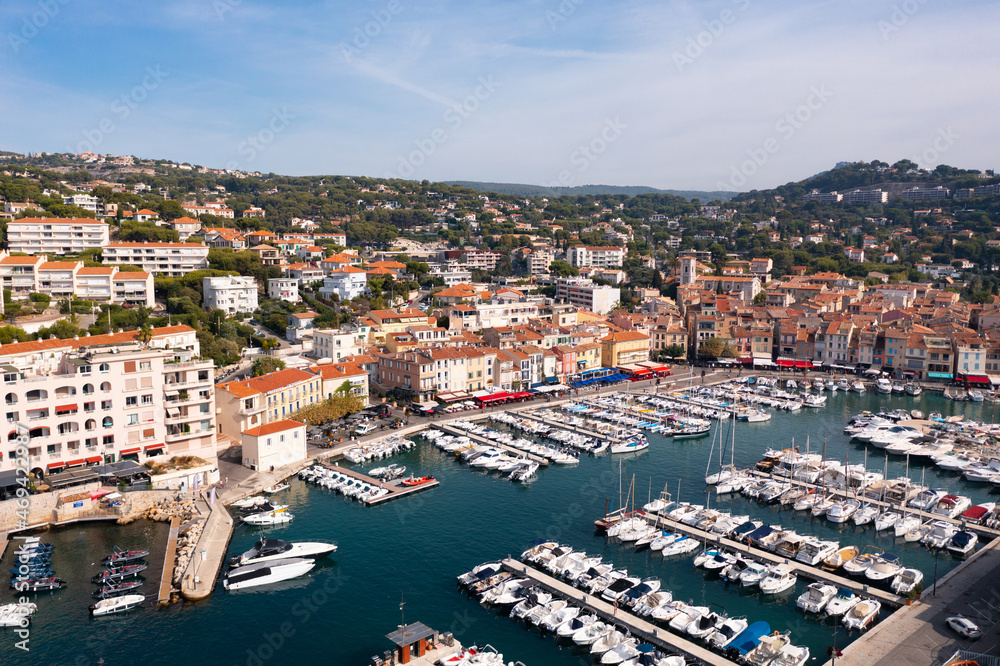 Picturesque aerial view of Cassis cityscape on Mediterranean coast with marina on sunny autumn day, Southern France.