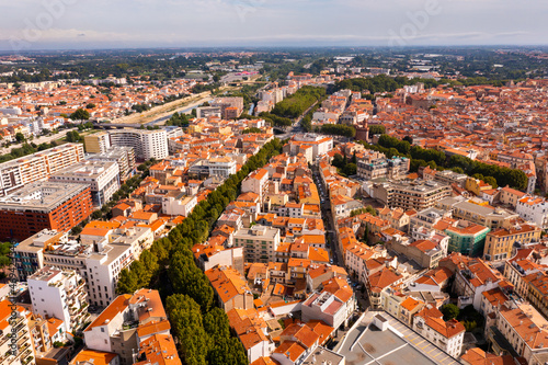 Bird's eye view of Perpignan, France. Red rooftops of residential buildings visible from above.