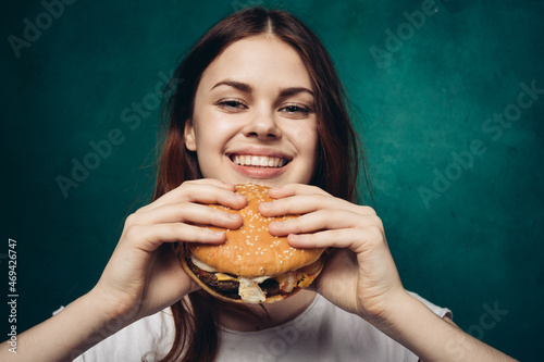 woman eating hamburger fast food snack close-up