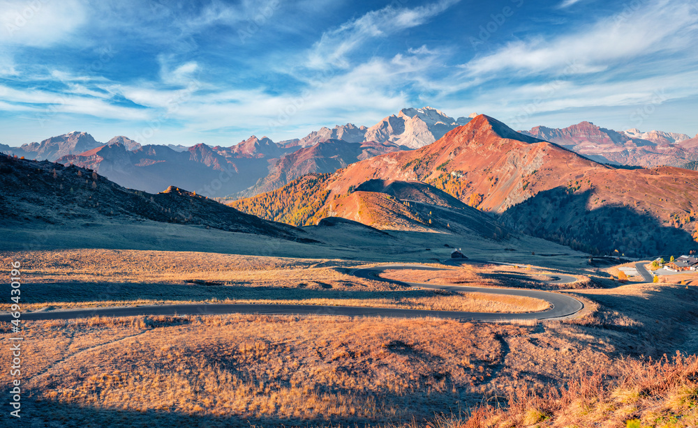 Fototapeta premium Spectacular autumn view of winding road in Dolomite Alps. Stunning landscape of Giau pass, province of Belluno in Italy. Fantastic morning scene of mountain valley. Traveling concept background.