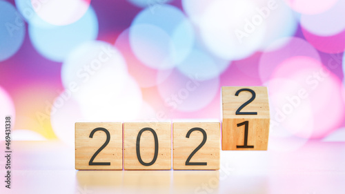 woodblocks cubes with a number 2021 change to 2022 on New year andchristmas background.