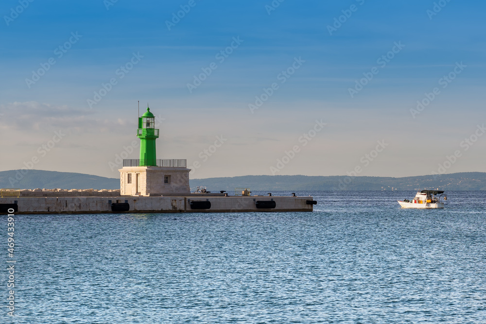 Split Lighthouse and boat in harbor in port of Adriatic sea coast, Split, Croatia.