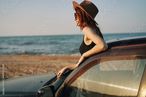 pretty woman in sunglasses near the car on the beach travel lifestyle © VICHIZH