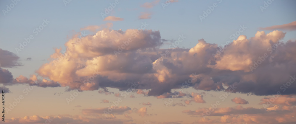 Beautiful fluffy clouds on sunny day at golden hour painted with sun Beautiful fluffy clouds on sunny day at golden hour painted with sun