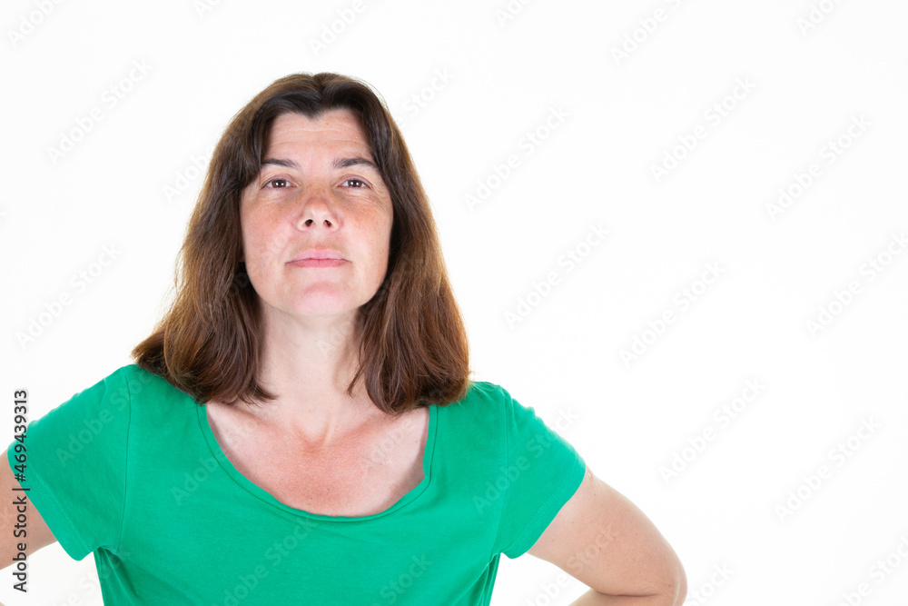 middle aged woman looking at camera posing against white background middle aged woman looking at camera posing against white background