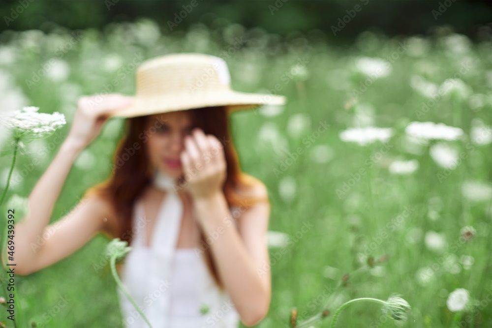 Woman with hat in a field of flowers nature freedom