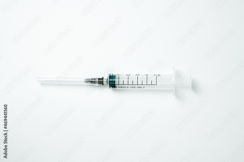 Medical syringe and needle on a light background Medical syringe and needle on a light background