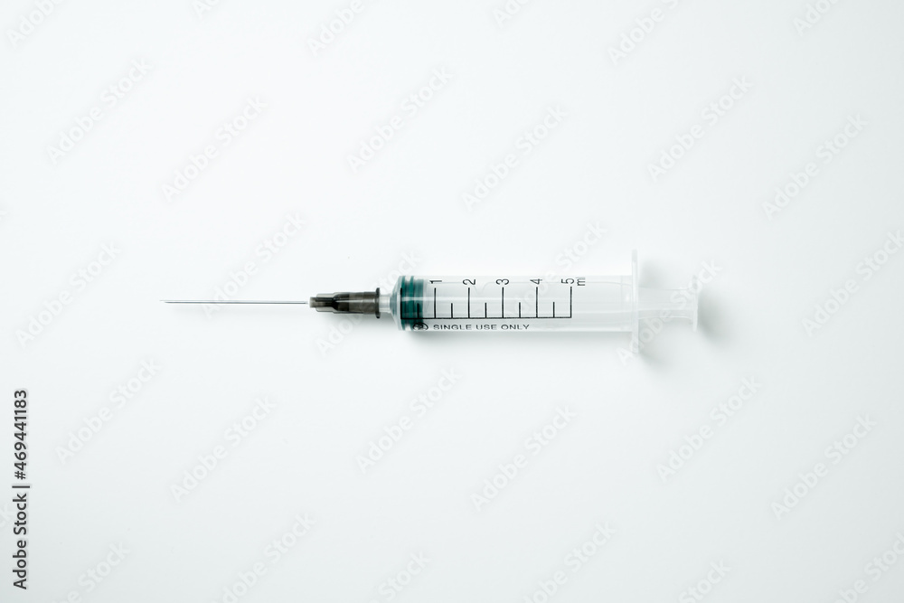 Medical syringe and needle on a light background Medical syringe and needle on a light background