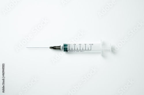 Medical syringe and needle on a light background