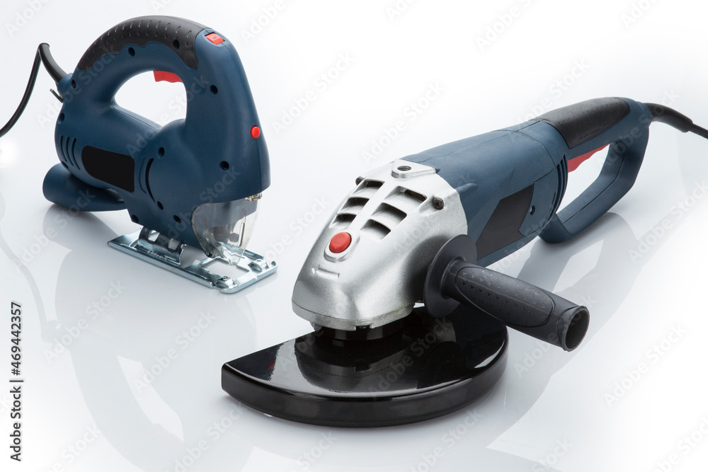 Set of professional tool electric jigsaw and angle grinder isolated on white background. Electric hand tools. Set of professional tool electric jigsaw and angle grinder isolated on white background. Electric hand tools.