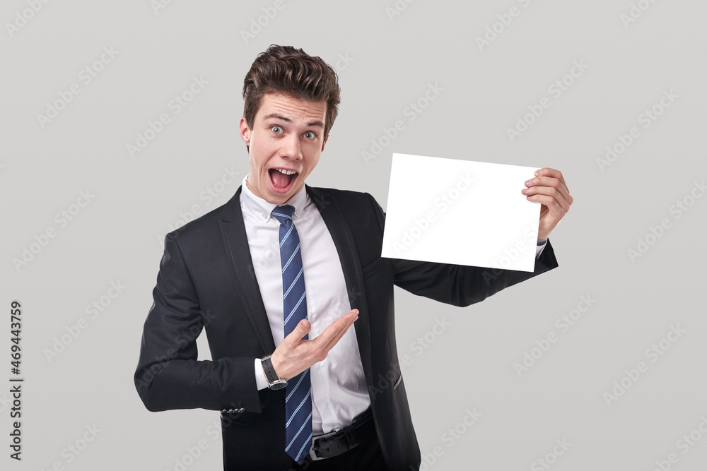 Businessman with blank paper in studio Businessman with blank paper in studio