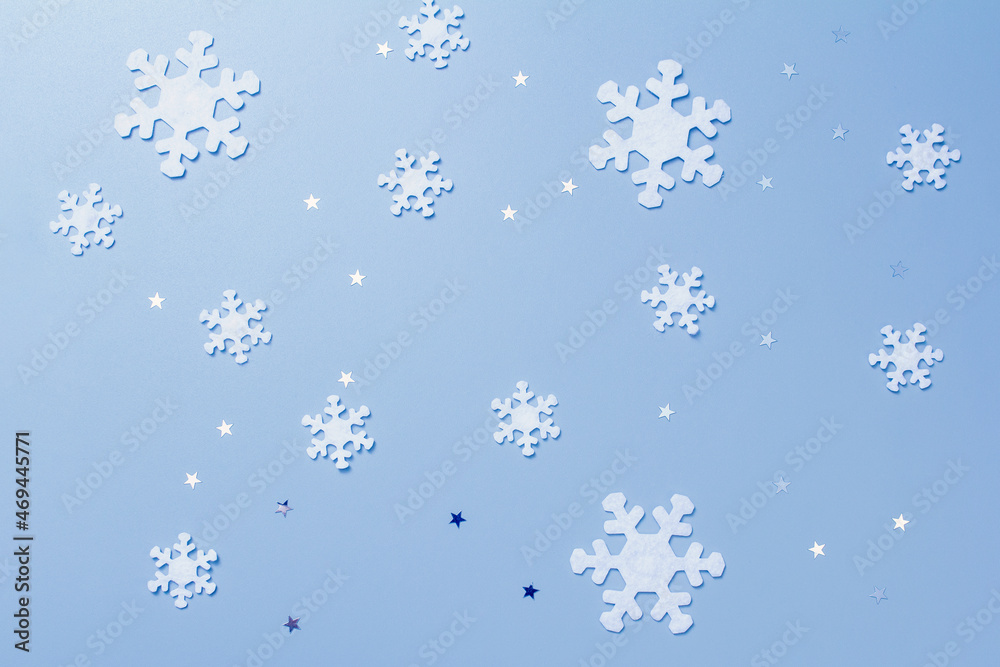 felt snowflakes, shining stars on a blue background. Christmas background.