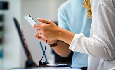 Tech shopping device gadget concept. Happy young people buying a new smartphone in mobile shop.