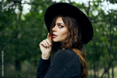 woman dressed as a witch in the forest Halloween fantasy ritual