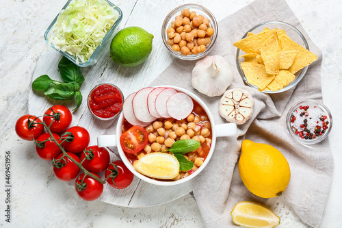 Composition with delicious pozole soup and ingredients on light background
