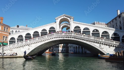 Europe, Italy, Venice November 2021 - Gondolas in Canal Grande with tourist and gondolier in Rialto bridge famous attraction in city of love  photo